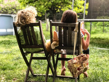 children on chairs talking